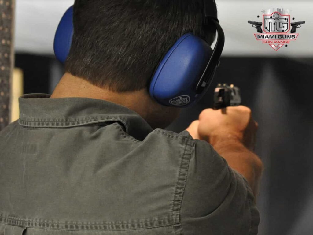 Man wearing headphones for protection about to shoot at Gun Range
